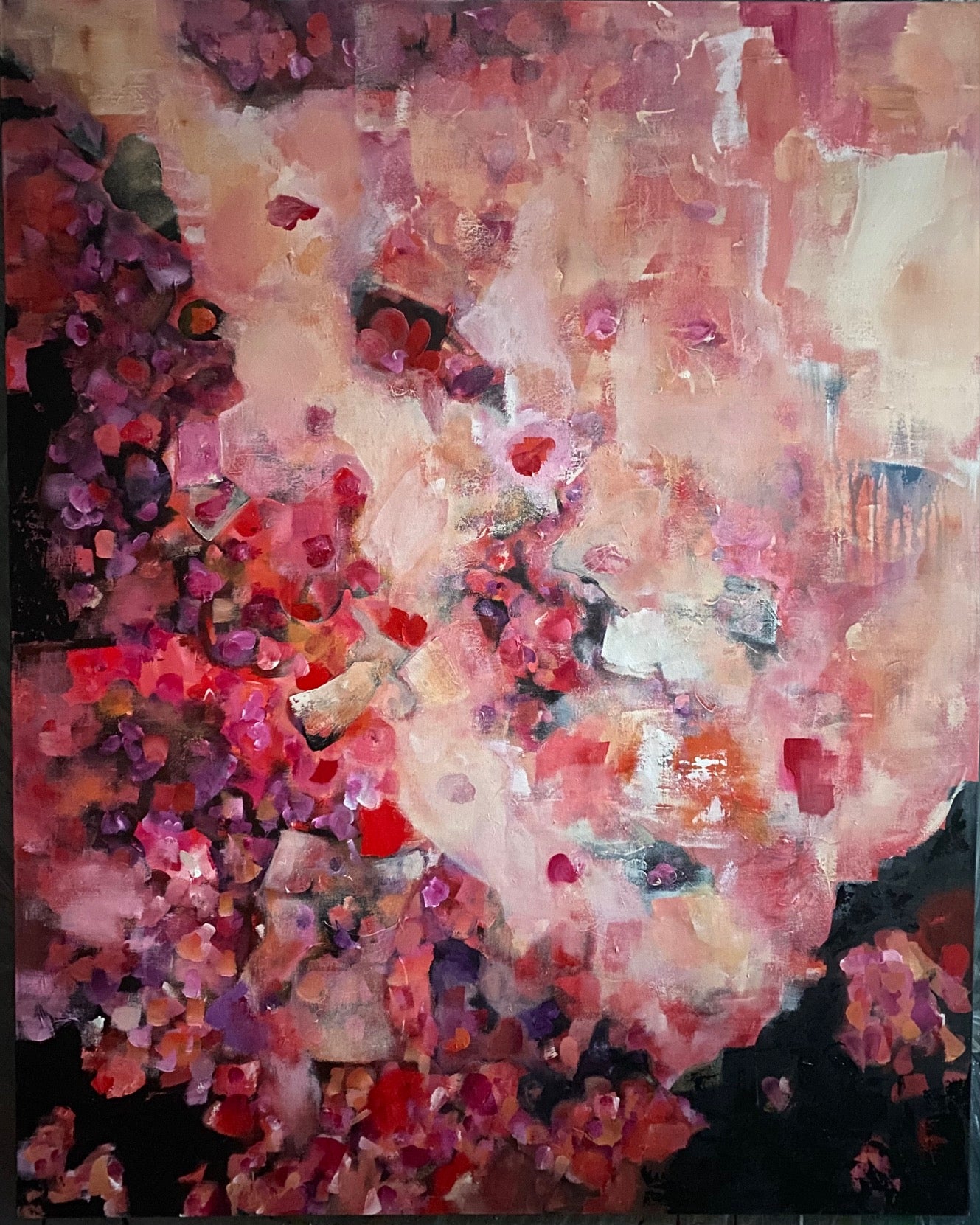 An abstract artwork featuring a mix of pink and red hues.